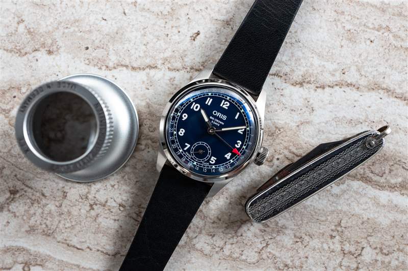 桌子上放著一臺 Oris BC 403，還有放大鏡和小折刀。